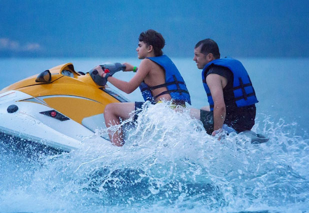 Jet skis racing across turquoise water
